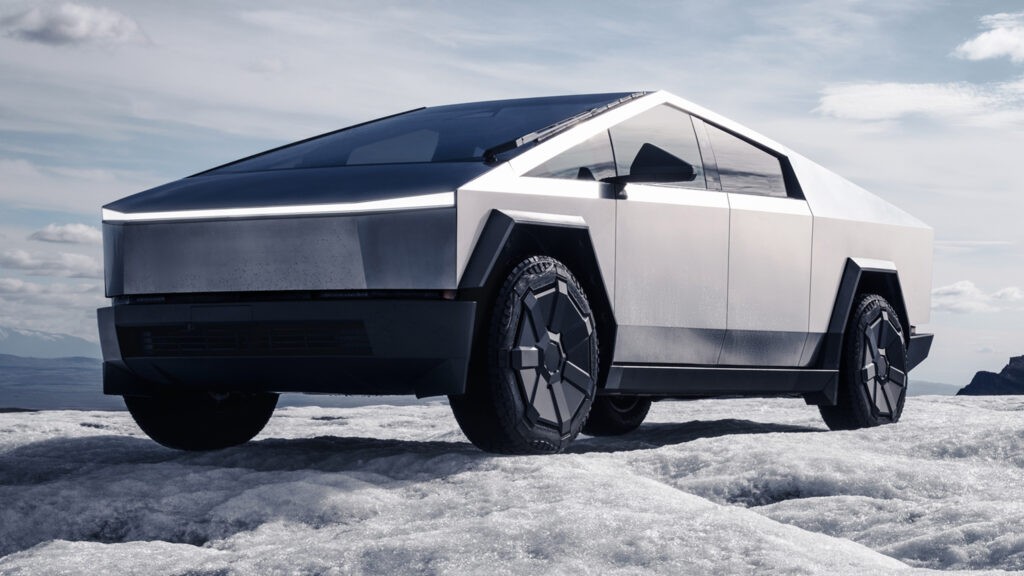 Tesla Cybertruck on display outdoors against dramatic overcast sky